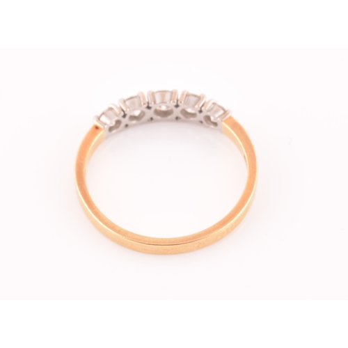 72 - An 18ct yellow gold and diamond ring, set with five graduated round-cut diamonds, the central diamon... 