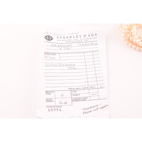 76 - A pair of 18ct yellow gold, diamond, and pearl stud earrings, (together with original receipt of pur... 