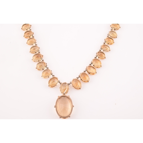 77 - A citrine riviere necklace, claw-set in silver gilt mount, the large mixed oval-cut drop measuring a... 