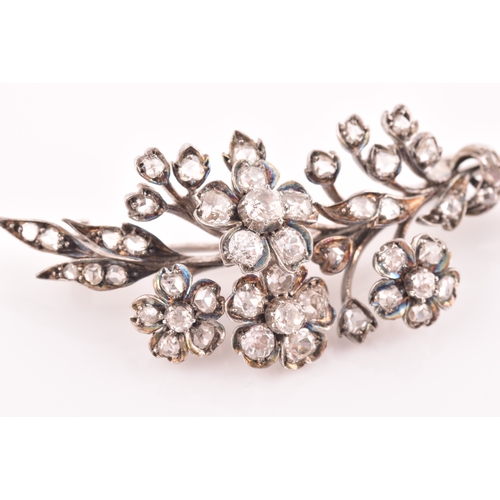 78 - A Victorian diamond floral spray brooch, the flowers and leaves inset with old-cut diamonds, the lar... 