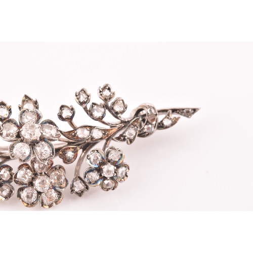 78 - A Victorian diamond floral spray brooch, the flowers and leaves inset with old-cut diamonds, the lar... 