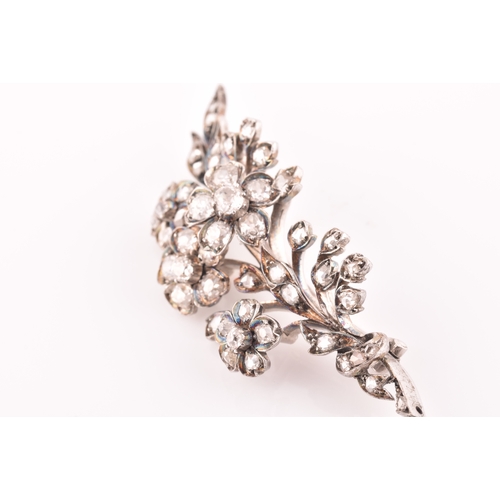 78 - A Victorian diamond floral spray brooch, the flowers and leaves inset with old-cut diamonds, the lar... 