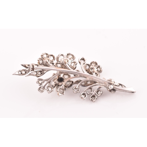 78 - A Victorian diamond floral spray brooch, the flowers and leaves inset with old-cut diamonds, the lar... 