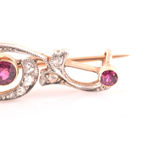 80 - A late 19th / early 20th century diamond and ruby bar brooch, the scrolled mount inset with old rose... 