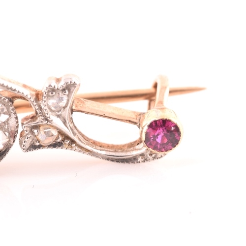 80 - A late 19th / early 20th century diamond and ruby bar brooch, the scrolled mount inset with old rose... 