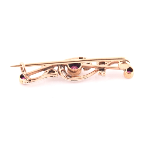 80 - A late 19th / early 20th century diamond and ruby bar brooch, the scrolled mount inset with old rose... 