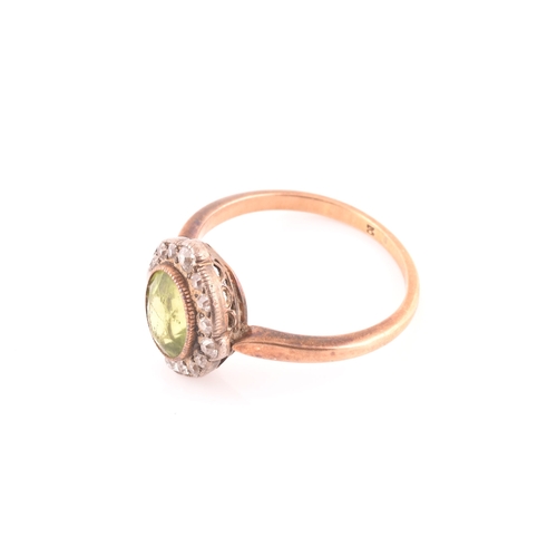 82 - A late 19th century peridot and diamond cluster ring, centred with a mixed oval-cut peridot, the bor... 