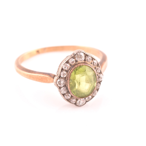 82 - A late 19th century peridot and diamond cluster ring, centred with a mixed oval-cut peridot, the bor... 