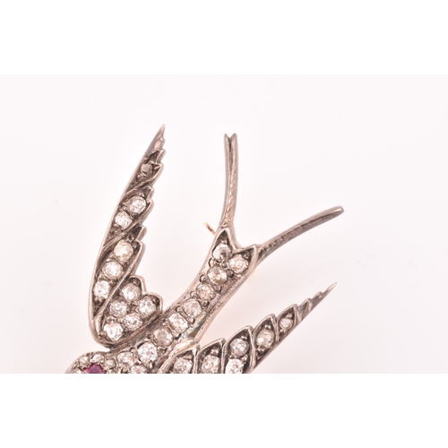 2 - A late Victorian diamond swallow brooch, the bird inset with old-cut diamonds, with a small ruby eye... 