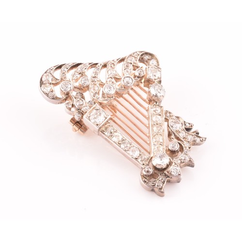 84 - A late 19th / early 20th diamond harp brooch, the scrolled decorative mount inset with mixed old-cut... 