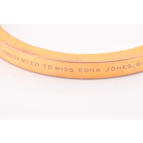 85 - An early 20th century 9ct yellow gold hollow bangle, the bracelet bearing personalised inscription: ... 