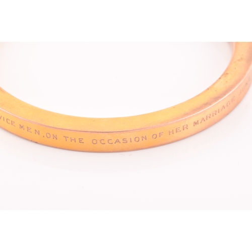 85 - An early 20th century 9ct yellow gold hollow bangle, the bracelet bearing personalised inscription: ... 