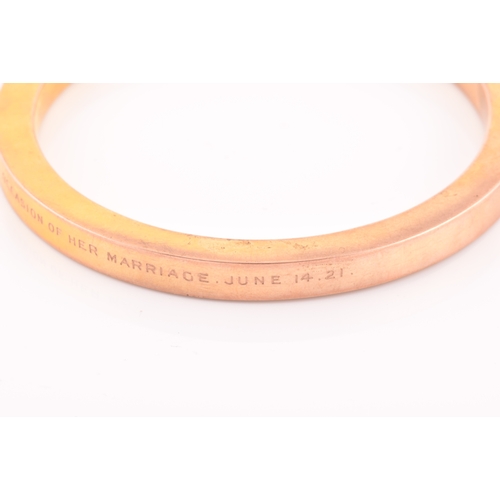 85 - An early 20th century 9ct yellow gold hollow bangle, the bracelet bearing personalised inscription: ... 