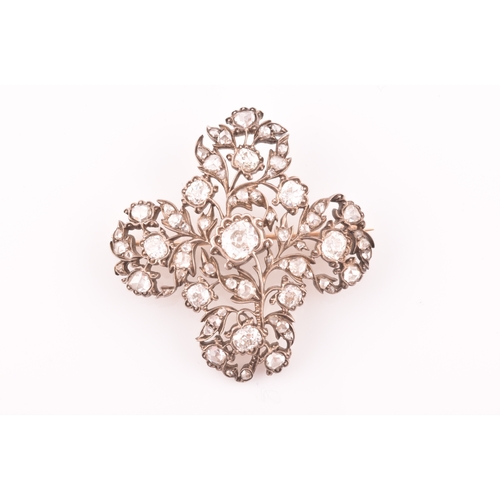 88 - A late Victorian diamond quatrefoil brooch, set with mixed old-cut diamonds, the openwork mount with... 