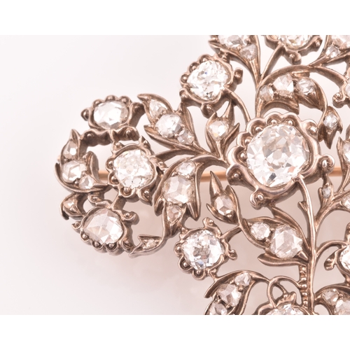 88 - A late Victorian diamond quatrefoil brooch, set with mixed old-cut diamonds, the openwork mount with... 