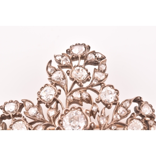 88 - A late Victorian diamond quatrefoil brooch, set with mixed old-cut diamonds, the openwork mount with... 