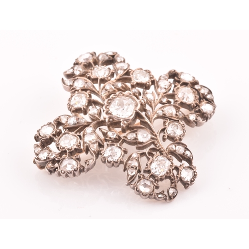 88 - A late Victorian diamond quatrefoil brooch, set with mixed old-cut diamonds, the openwork mount with... 