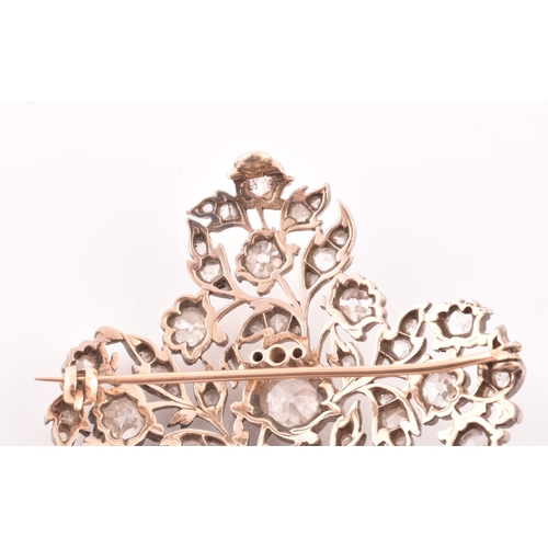 88 - A late Victorian diamond quatrefoil brooch, set with mixed old-cut diamonds, the openwork mount with... 