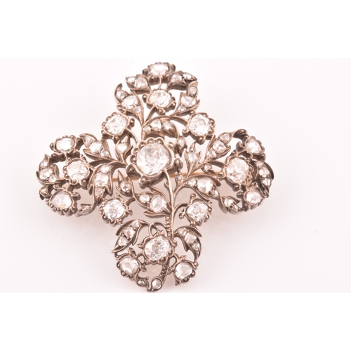 88 - A late Victorian diamond quatrefoil brooch, set with mixed old-cut diamonds, the openwork mount with... 