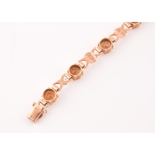 90 - A 9ct yellow gold and orange citrine bracelet, fancy links interspersed with eight round-cut claw-se... 