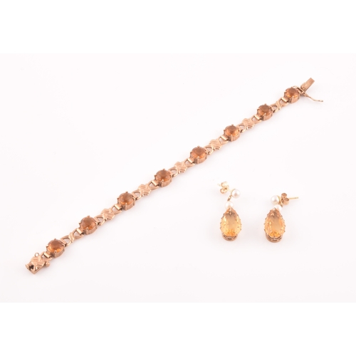 90 - A 9ct yellow gold and orange citrine bracelet, fancy links interspersed with eight round-cut claw-se... 