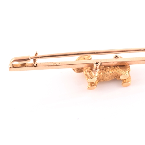 91 - A 15ct yellow gold bar brooch, mounted with a small terrier with textured fur, brooch 5.1 cm long, t... 