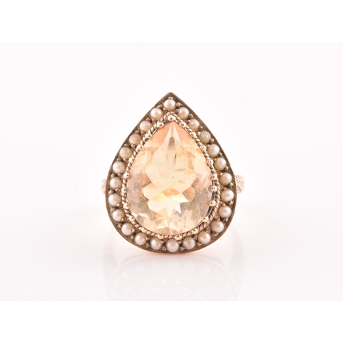 94 - A 9ct yellow gold, citrine, and seed pearl ring, the pear-shaped central citrine measuring approxima... 