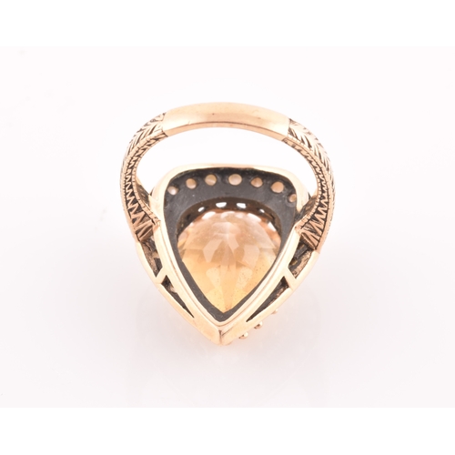 94 - A 9ct yellow gold, citrine, and seed pearl ring, the pear-shaped central citrine measuring approxima... 