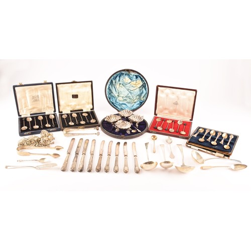 180 - A collection of silver items including a set of four shell shaped salts, silver cased coffee bean en... 