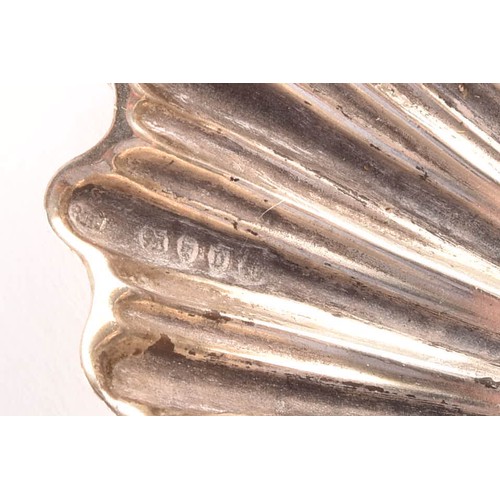 180 - A collection of silver items including a set of four shell shaped salts, silver cased coffee bean en... 