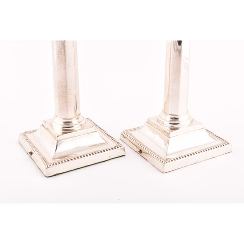 184 - A pair of Edwardian silver candlesticks hallmarked Sheffield 1906, by Martin, Hall & Co (Richard... 