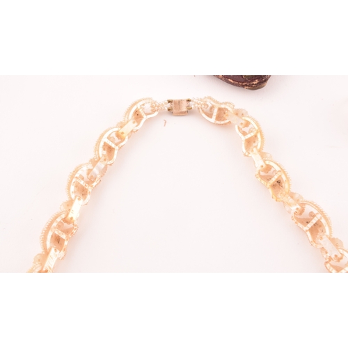 100 - A late 19th century seed pearl necklace (lacking pendant), the curved links sewn with pierced seed p... 