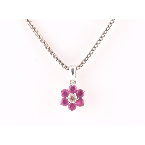 101 - An 18ct white gold, diamond, and ruby floral cluster pendant, centred with a round brilliant-cut dia... 