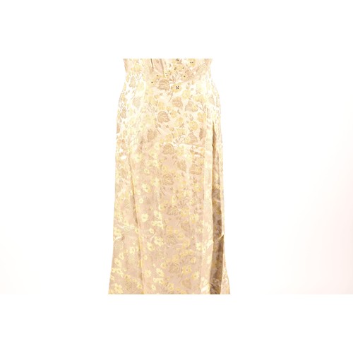 302 - A 1950s full length satin and silk dress embroidered with gold and green leaves on a silver grey gro... 