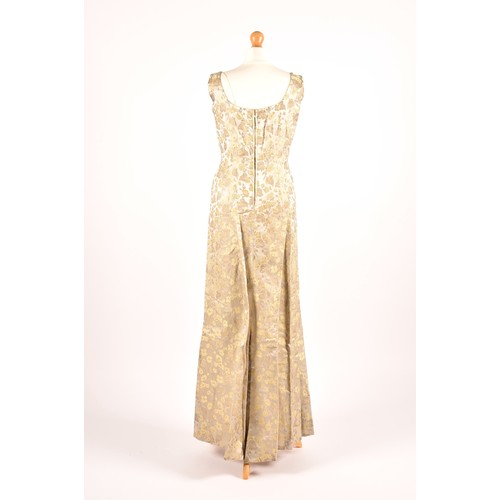 302 - A 1950s full length satin and silk dress embroidered with gold and green leaves on a silver grey gro... 