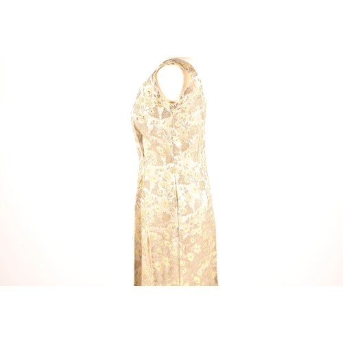 302 - A 1950s full length satin and silk dress embroidered with gold and green leaves on a silver grey gro... 