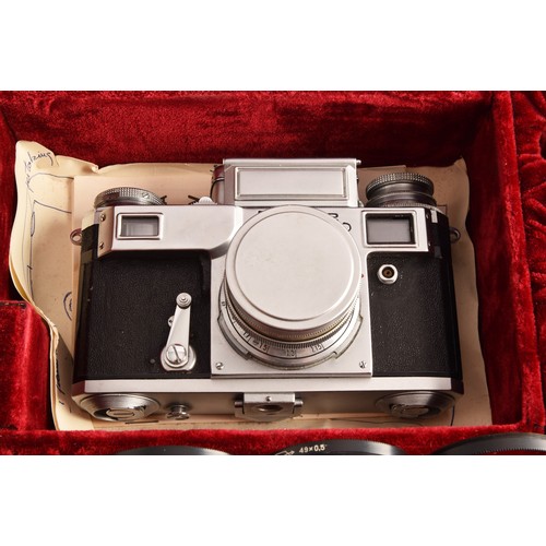 304 - A boxed Kiev 35mm camera and lens set of political interest, in a fitted box together with several l... 