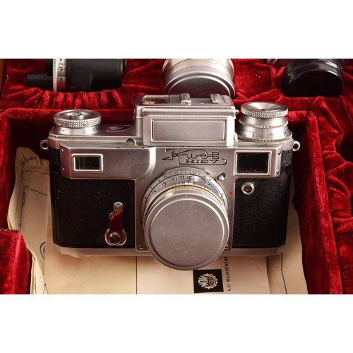 304 - A boxed Kiev 35mm camera and lens set of political interest, in a fitted box together with several l... 