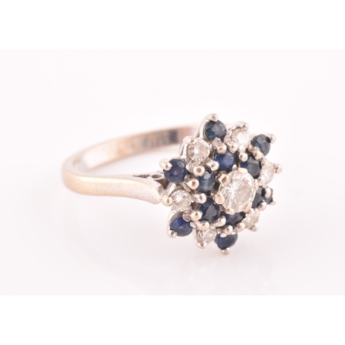 105 - An 18ct white gold, diamond, and sapphire cluster ring, centred with a round brilliant-cut diamond o... 