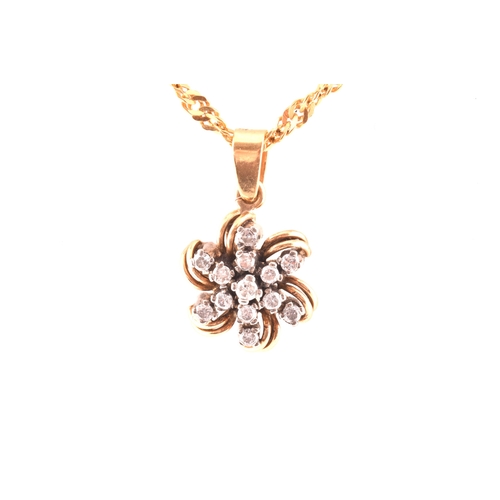 107 - A yellow metal and diamond floral diamond starburst pendant, set with thirteen round brilliant-cut d... 