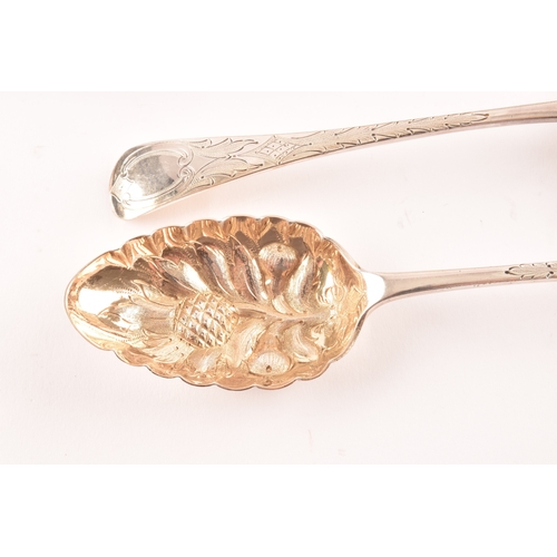 192 - A pair of Victorian silver serving spoons with later embossed floral decoration, together with a set... 