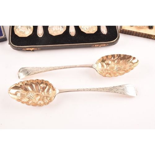 192 - A pair of Victorian silver serving spoons with later embossed floral decoration, together with a set... 