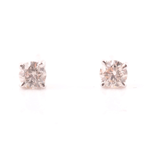 108 - A pair of 14ct white gold mounted solitaire diamond earrings, of approximately 0.30 carats combined.