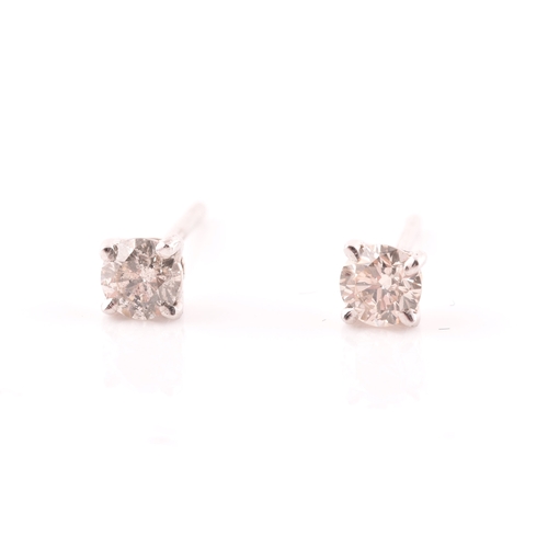 108 - A pair of 14ct white gold mounted solitaire diamond earrings, of approximately 0.30 carats combined.