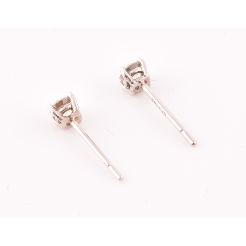 108 - A pair of 14ct white gold mounted solitaire diamond earrings, of approximately 0.30 carats combined.