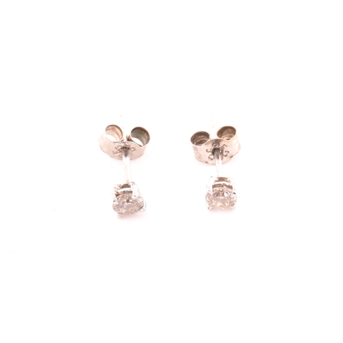 108 - A pair of 14ct white gold mounted solitaire diamond earrings, of approximately 0.30 carats combined.