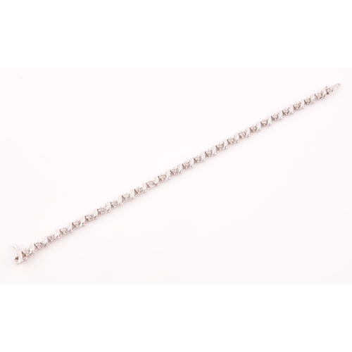 111 - A 14ct white gold and diamond line bracelet, the articulated links set with round brilliant-cut diam... 