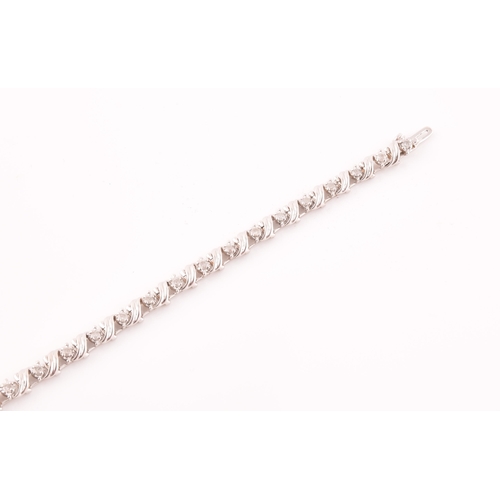 111 - A 14ct white gold and diamond line bracelet, the articulated links set with round brilliant-cut diam... 