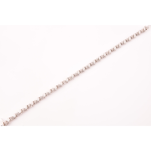 111 - A 14ct white gold and diamond line bracelet, the articulated links set with round brilliant-cut diam... 