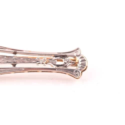 112 - A white and yellow metal bar brooch, in the Art Deco style, inset with a round brilliant-cut diamond... 